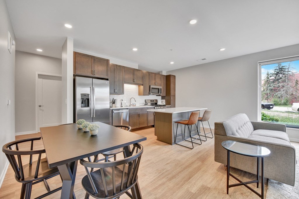 a kitchen and living room with wood flooring and a large window