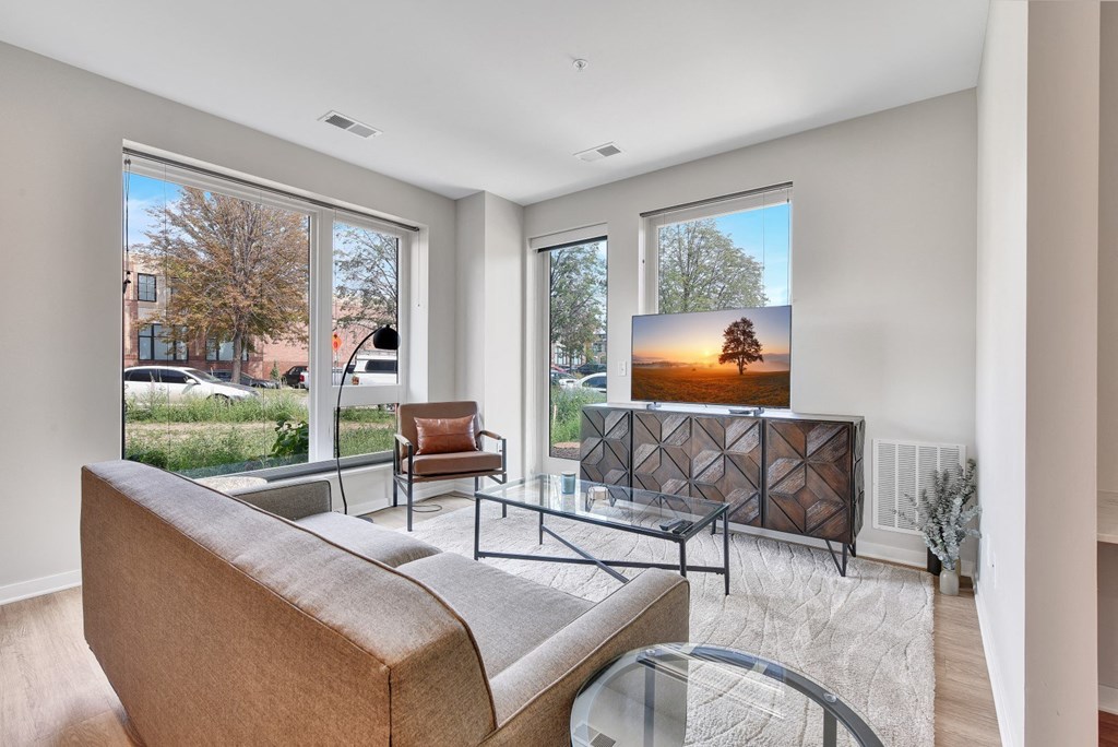a living room with a tv on the wall and a couch in front of it