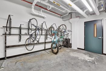 A bike rack with several bicycles on it.