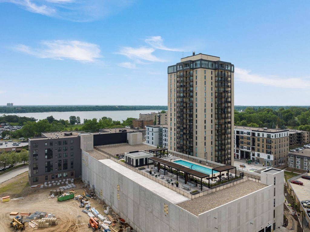 a view of a tall building with a pool in front of it