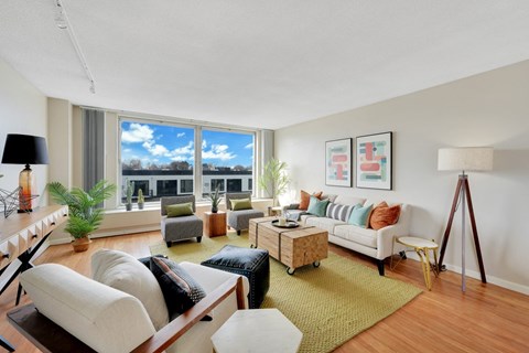 a living room with furniture and a large window  at The Original at West Lake Quarter, Minneapolis, Minnesota