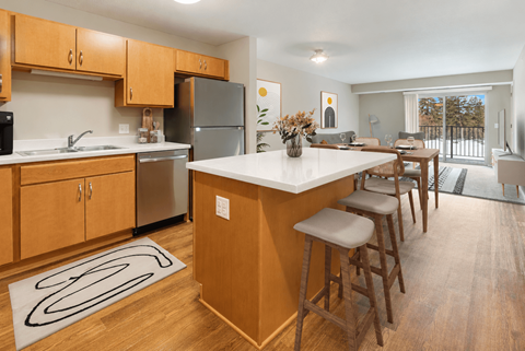 A kitchen with wooden cabinets and a white countertop.