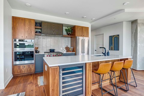A modern kitchen with wooden cabinets and a white countertop.