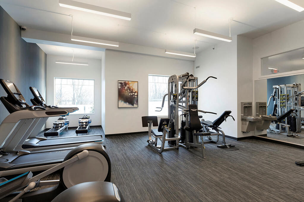 Multi-functional gym with 5 equipment stations for strength training at Waterstone Place in Minnetonka, MN