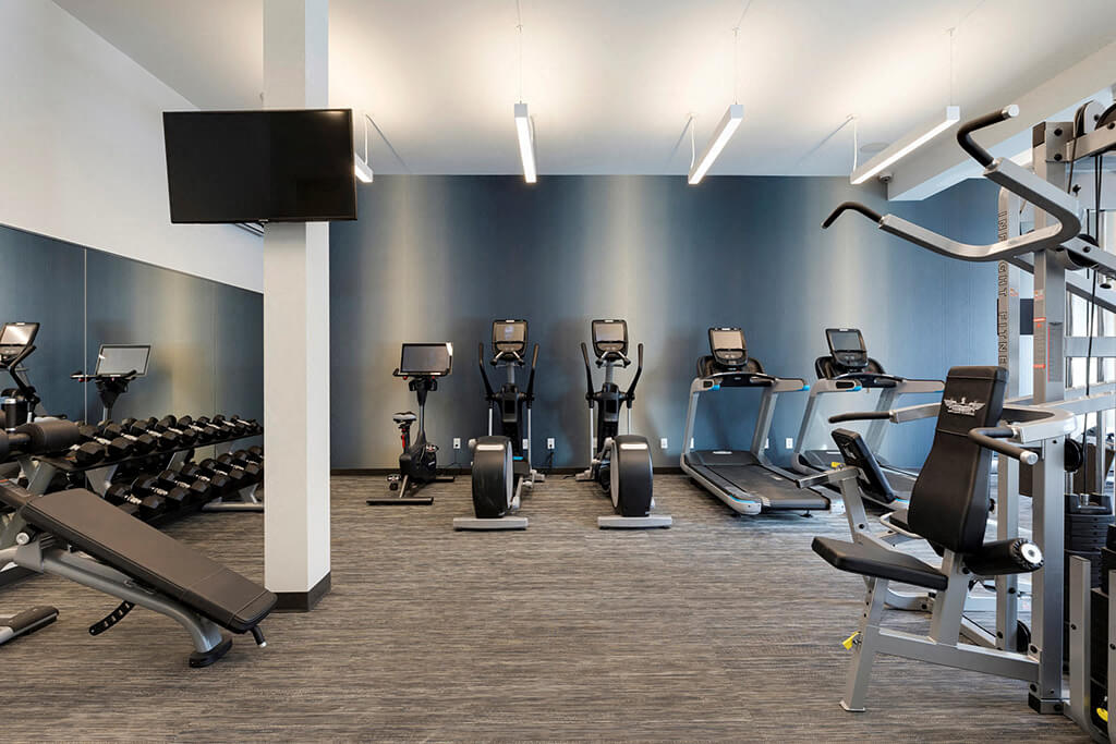 Free weights and decline and dumbbell benches in fitness center in Minnetonka apartment at Waterstone Place in MN
