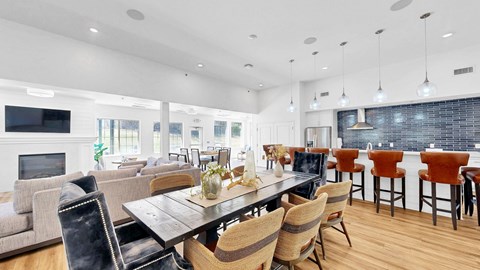 A modern dining room with a wooden table and chairs.