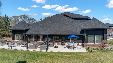 A black building with a blue umbrella in front.