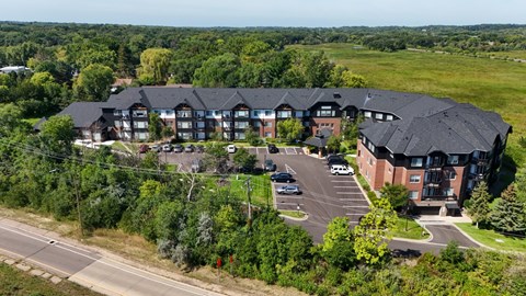 A large building with a parking lot in front of it.