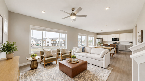 A living room with a white couch and a brown coffee table.