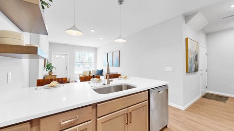 A modern kitchen with wooden cabinets and a white countertop.