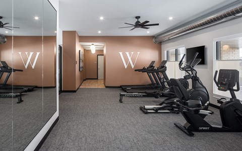 A gym with treadmills and exercise bikes.