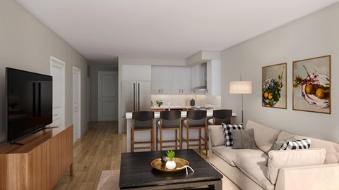 A modern living room with a flat screen TV, a dining table set for four, and a sofa with cushions.