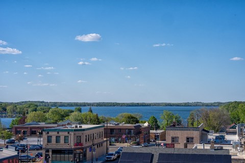 A view of a town with a lake in the background.