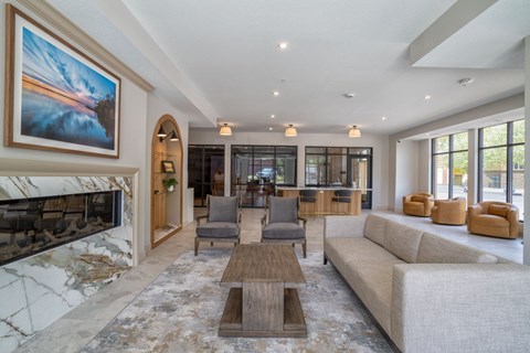 A living room with a fireplace and a large painting on the wall.