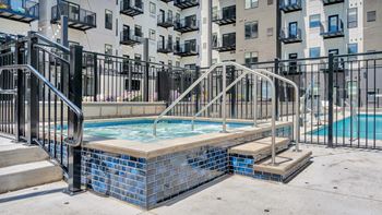 A small pool with a metal railing around it.