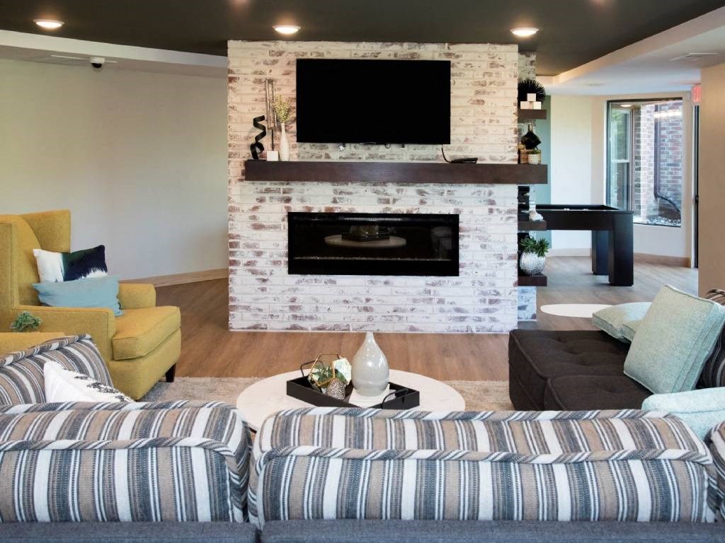 Couch, fireplace, tv, lounge in community room at Aspenwood Apartments, Eagan, MN