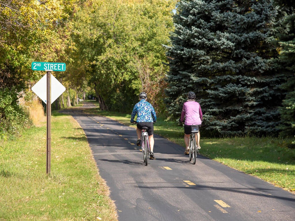 people biking on trails at Urban Park I and II Apartments, St Louis Park, MN