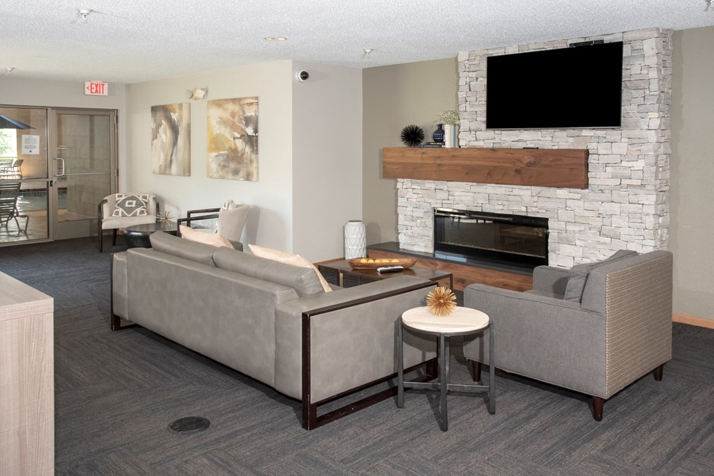 community room with seating, tv and fireplace