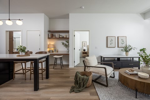 A modern living room with a dining table and chairs.