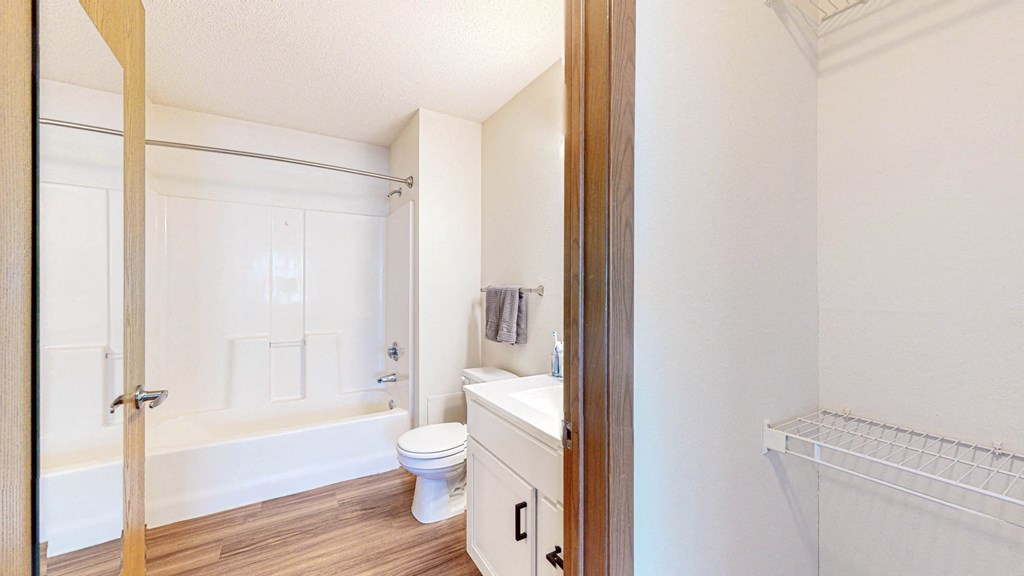 a bathroom with a toilet and a tub and a sink