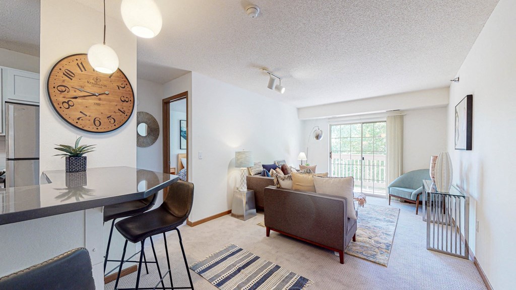 a living room with a large clock on the wall and a couch