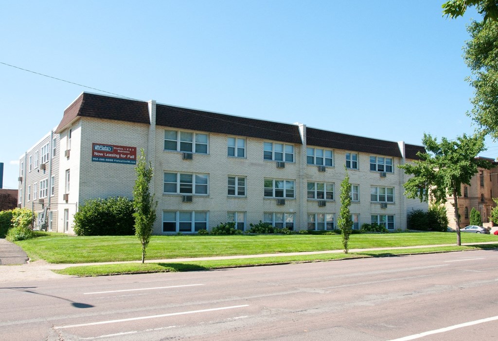 an apartment building on the side of a street