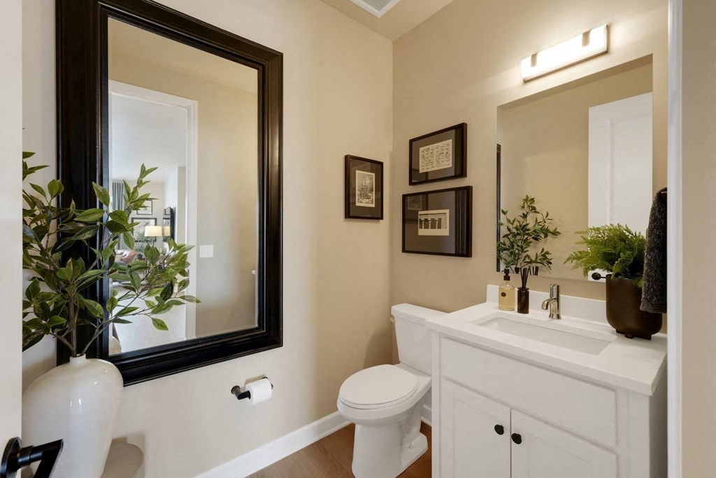a bathroom with a mirror and a toilet and a sink