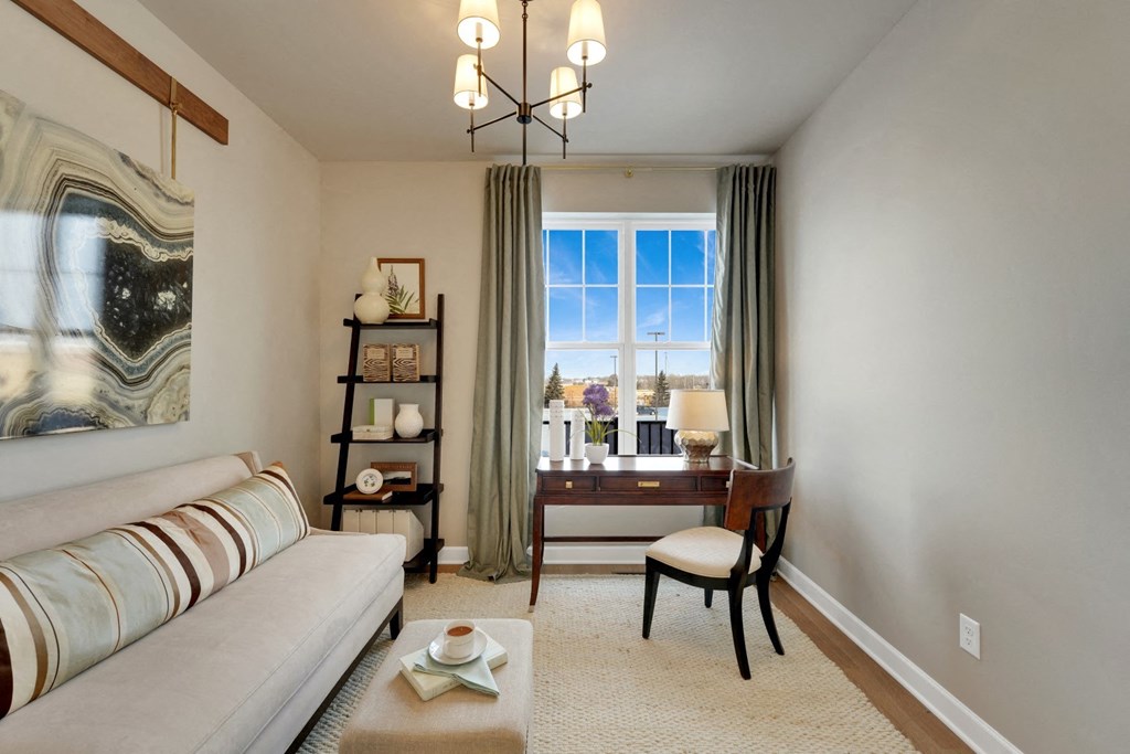 a living room with a white couch and a window