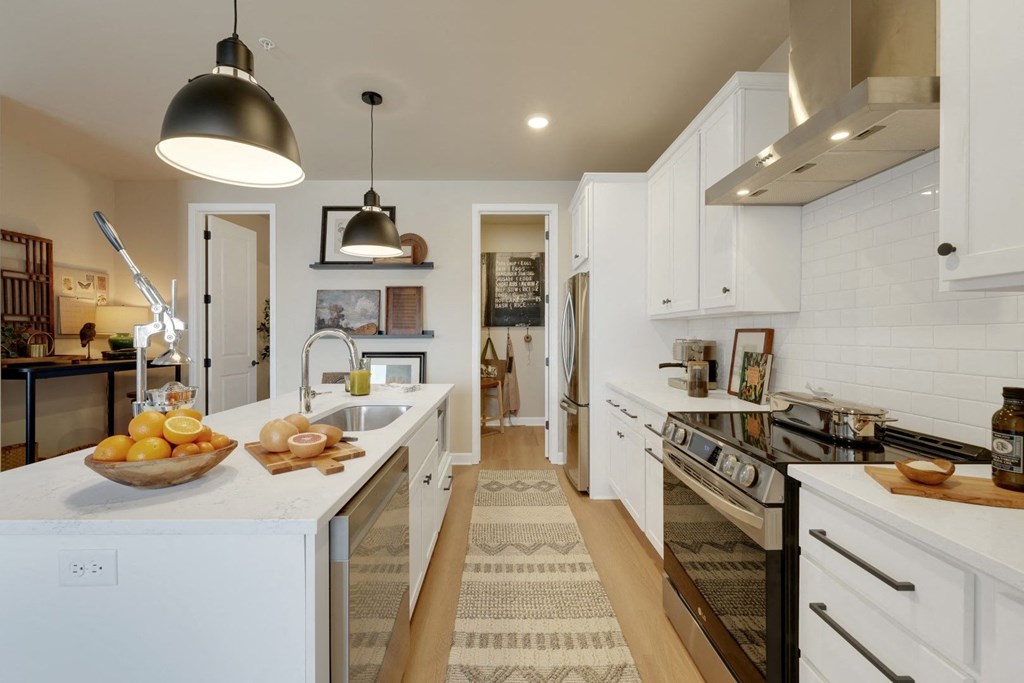 a large kitchen with white cabinets and a counter top