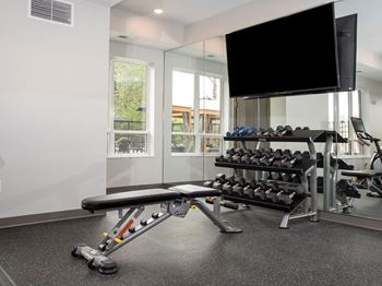 fitness room with weights at Urban Park I and II Apartments, St Louis Park, MN