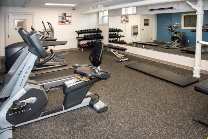 a gym with treadmills and other exercise equipment