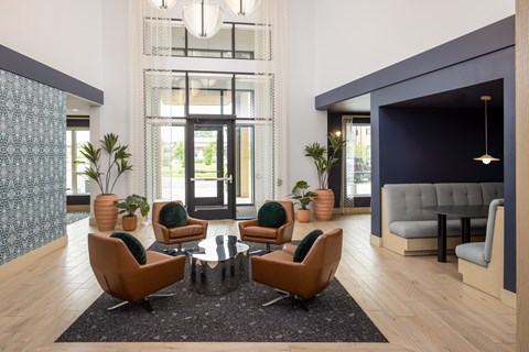 A modern living room with a glass door and a grey sofa.