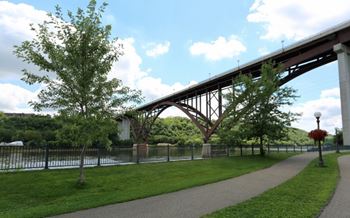 A bridge over a river with a walkway underneath.
