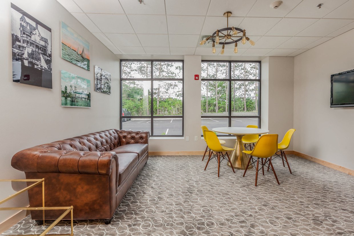 a living room with a couch and a table and chairs