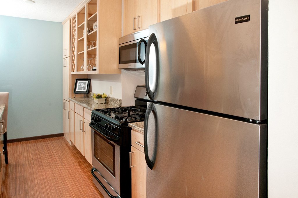 a kitchen with stainless steel appliances and a stove and refrigerator