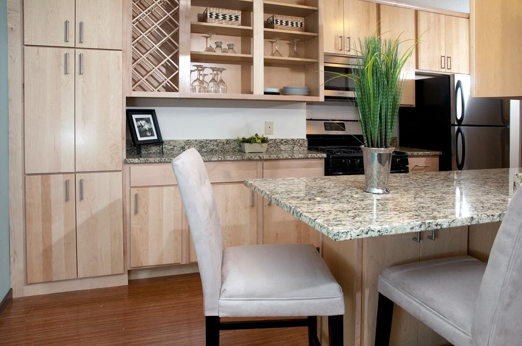 a kitchen with wooden cabinets and a granite counter top