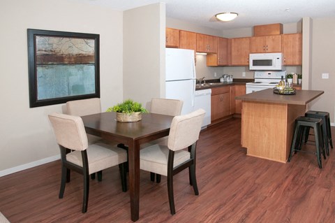 a kitchen and dining room with a table and chairs