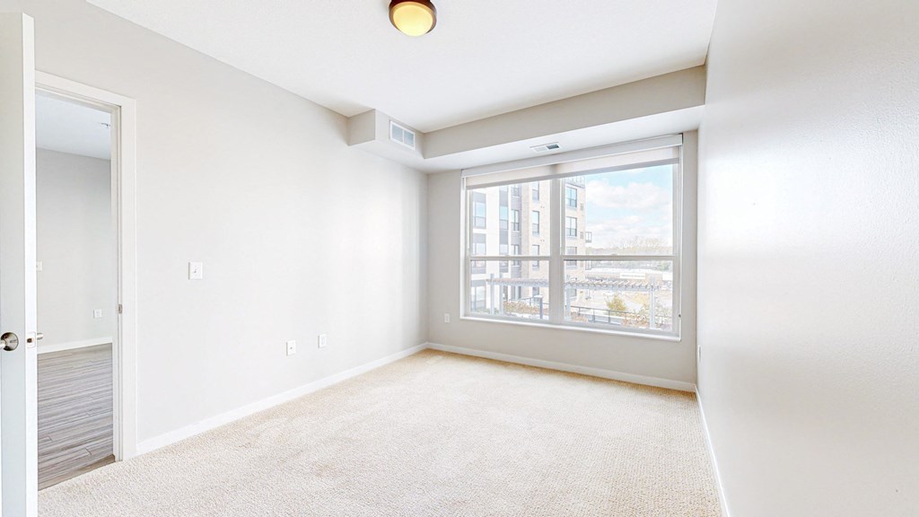 A room with a large window and a sliding door.