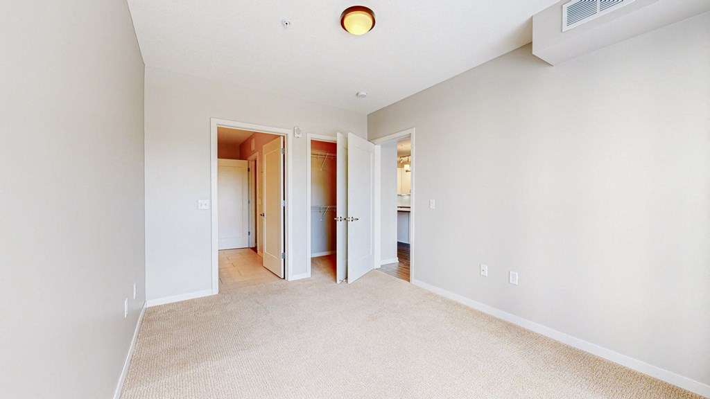 A room with white walls and a carpeted floor.