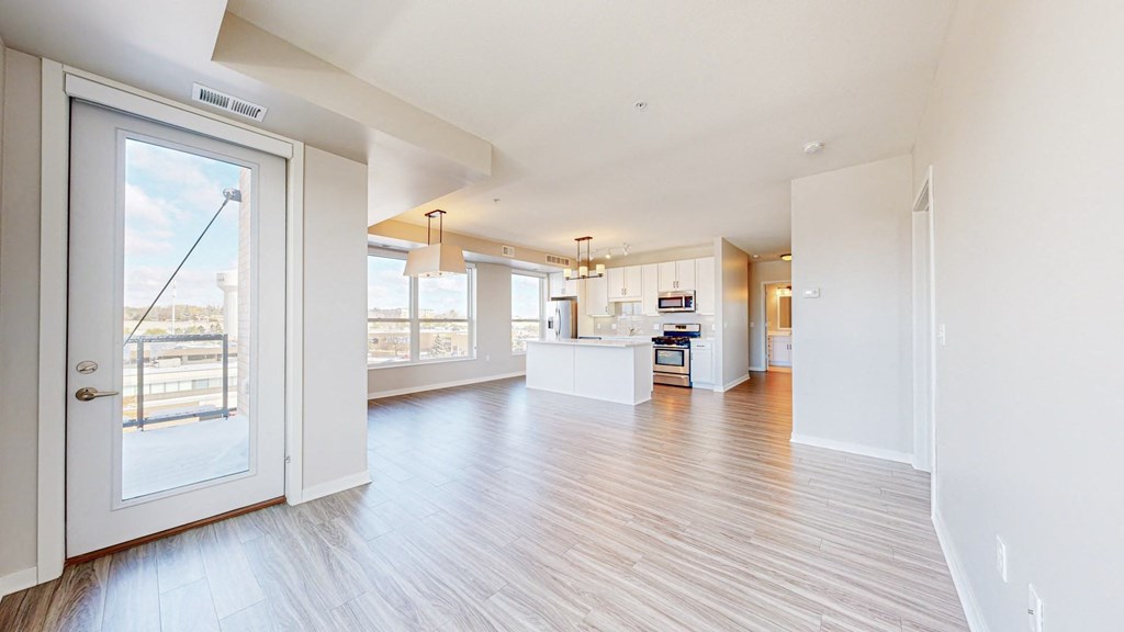 A spacious living room with a view of the city through the large windows.