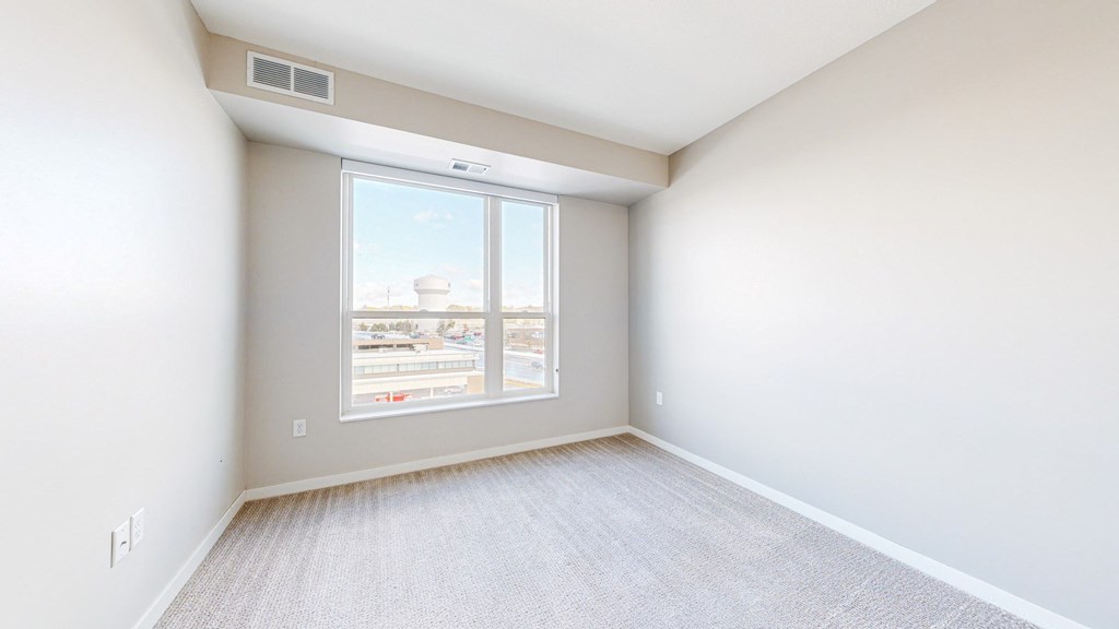 A room with a window overlooking a snowy landscape.