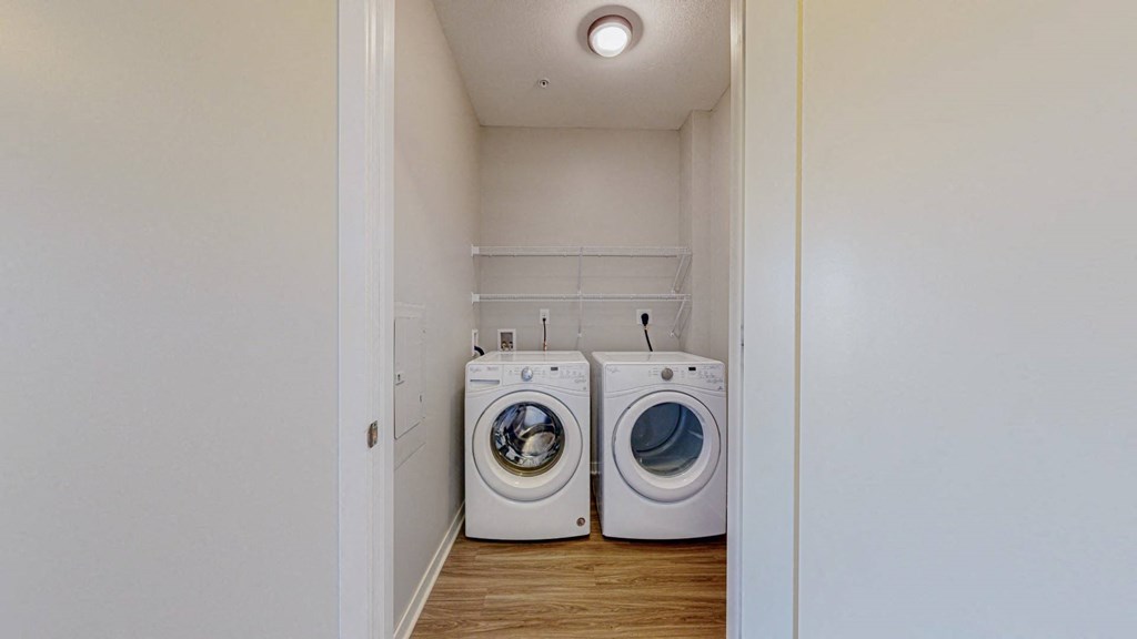 A laundry room with two washing machines.