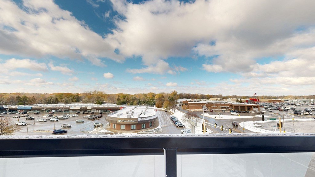 A parking lot with a circular building in the middle.
