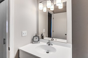 Bathroom With Vanity Lights at Audenn Apartments, Bloomington - Photo Gallery 18