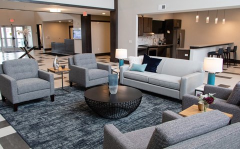 A living room with grey furniture and a black coffee table.