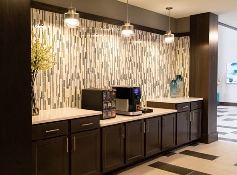 A modern kitchen with dark brown cabinets and a white countertop. A modern kitchen with dark brown cabinets and a white countertop.at The Edison at Avonlea, Lakeville Minnesota