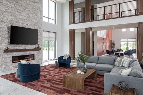 A modern living room with a fireplace and a television above it.