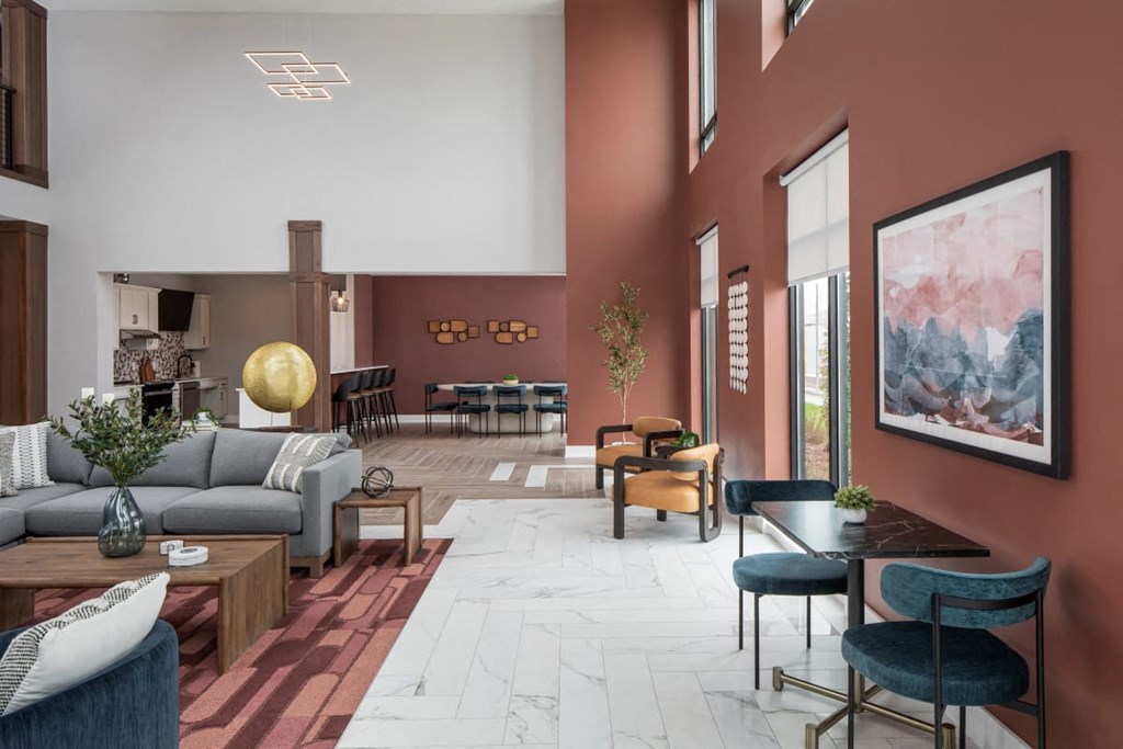 A modern living room with a grey sofa, a wooden coffee table, and a large painting on the wall.at The Edison at Maple Grove, Maple Grove Minnesota