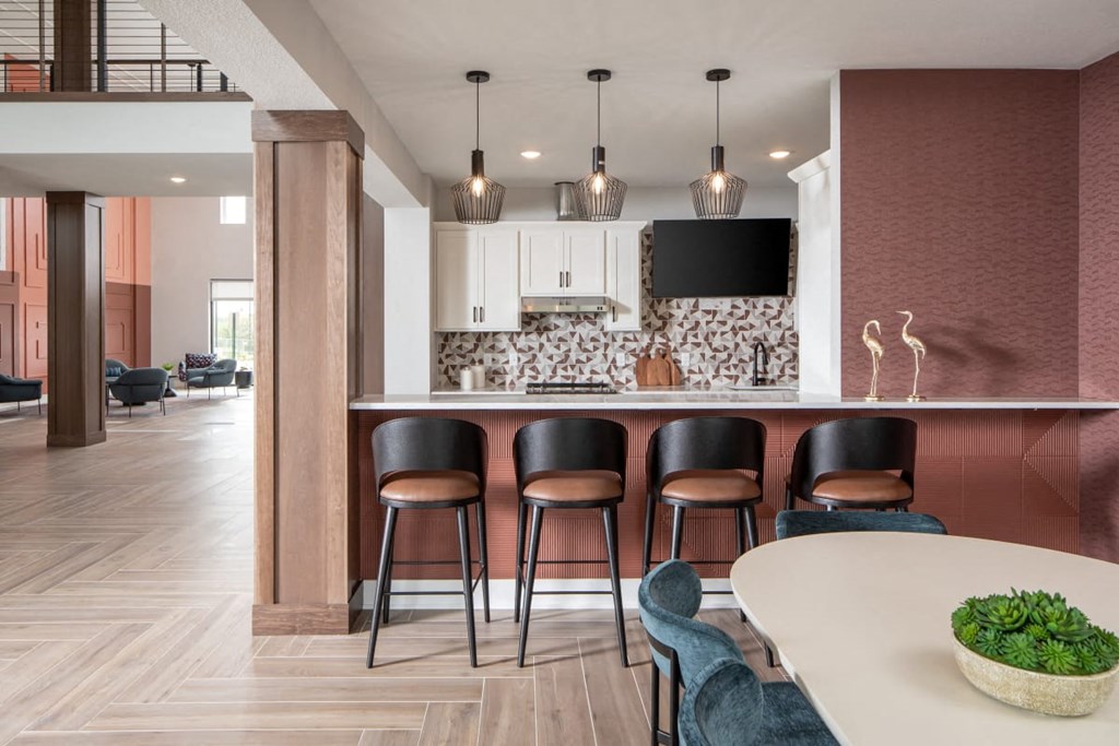 A modern kitchen with a bar area and seating.at The Edison at Maple Grove, Maple Grove, MN 55311