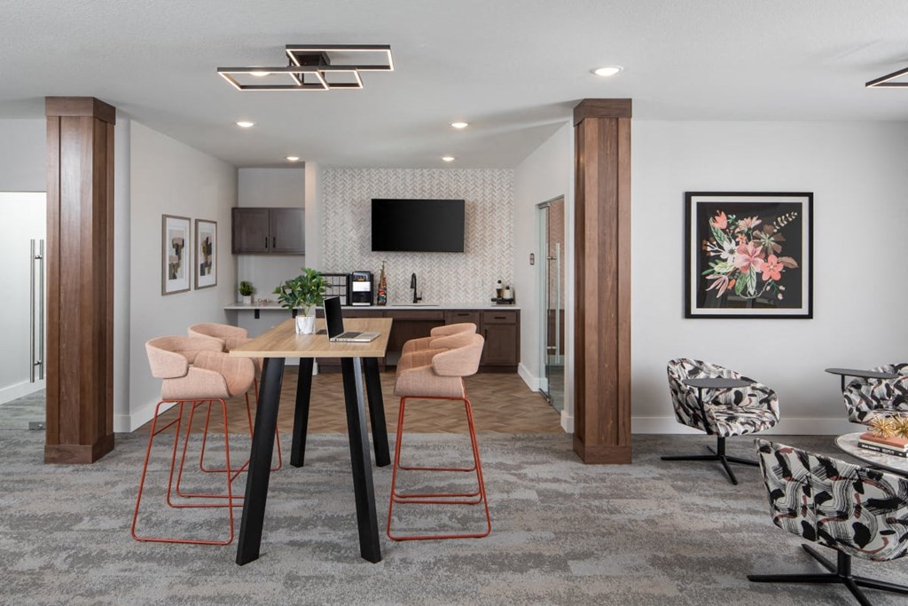 A modern dining room with a wooden table and chairs. A modern dining room with a wooden table and chairs.at The Edison at Maple Grove, Maple Grove